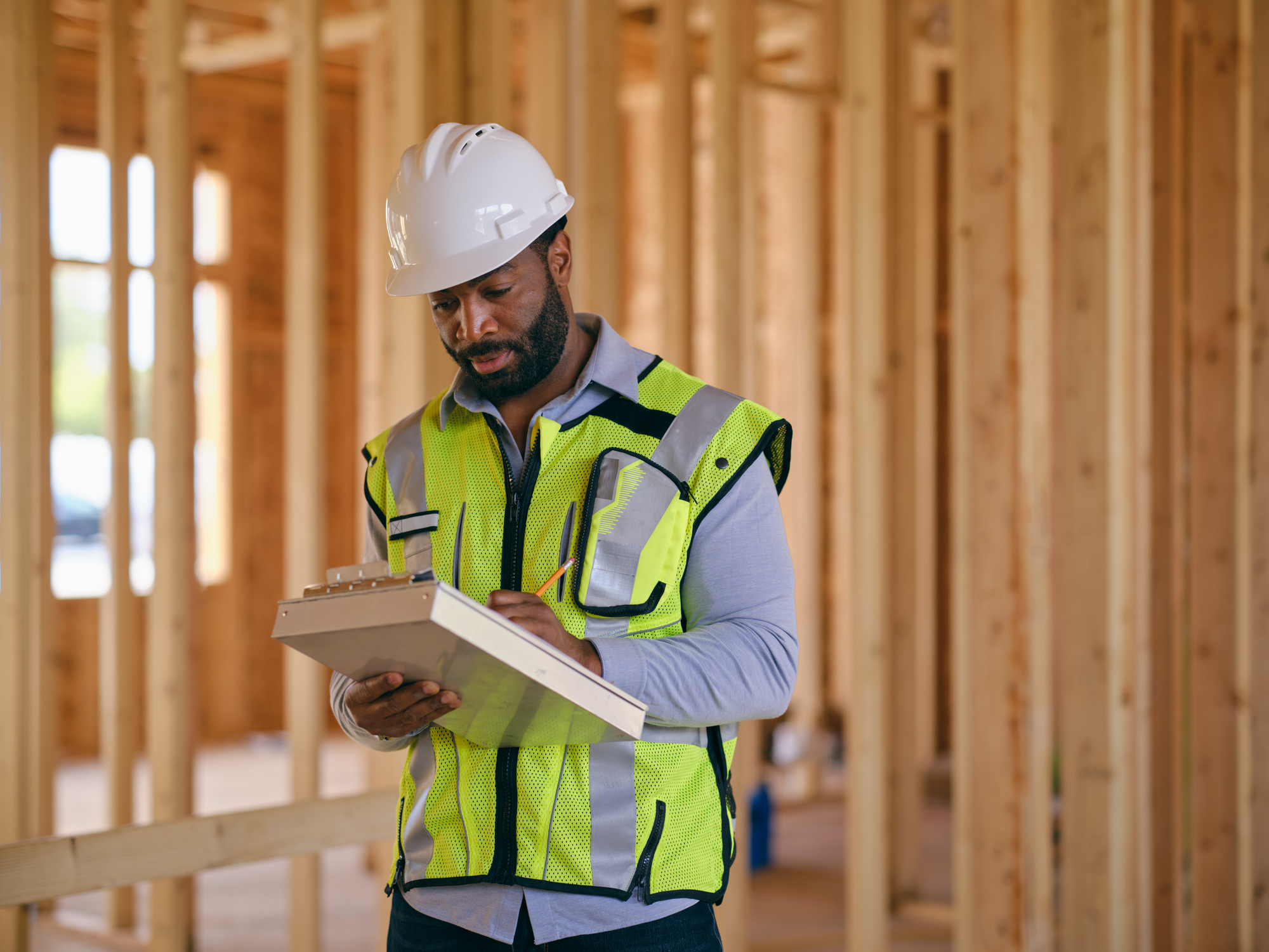 A man working through a checklist on a construction site