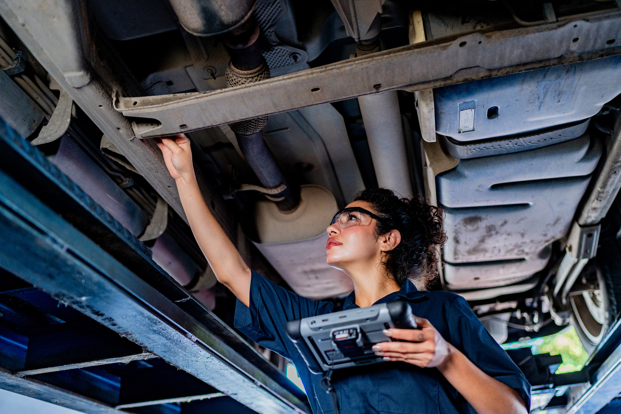 A women working underneath a car