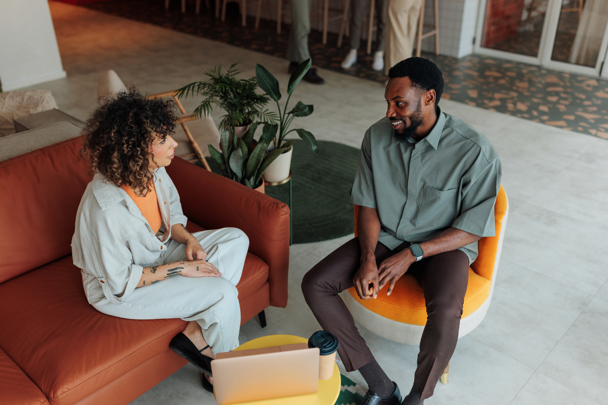 Two people sitting in an office having a conversation