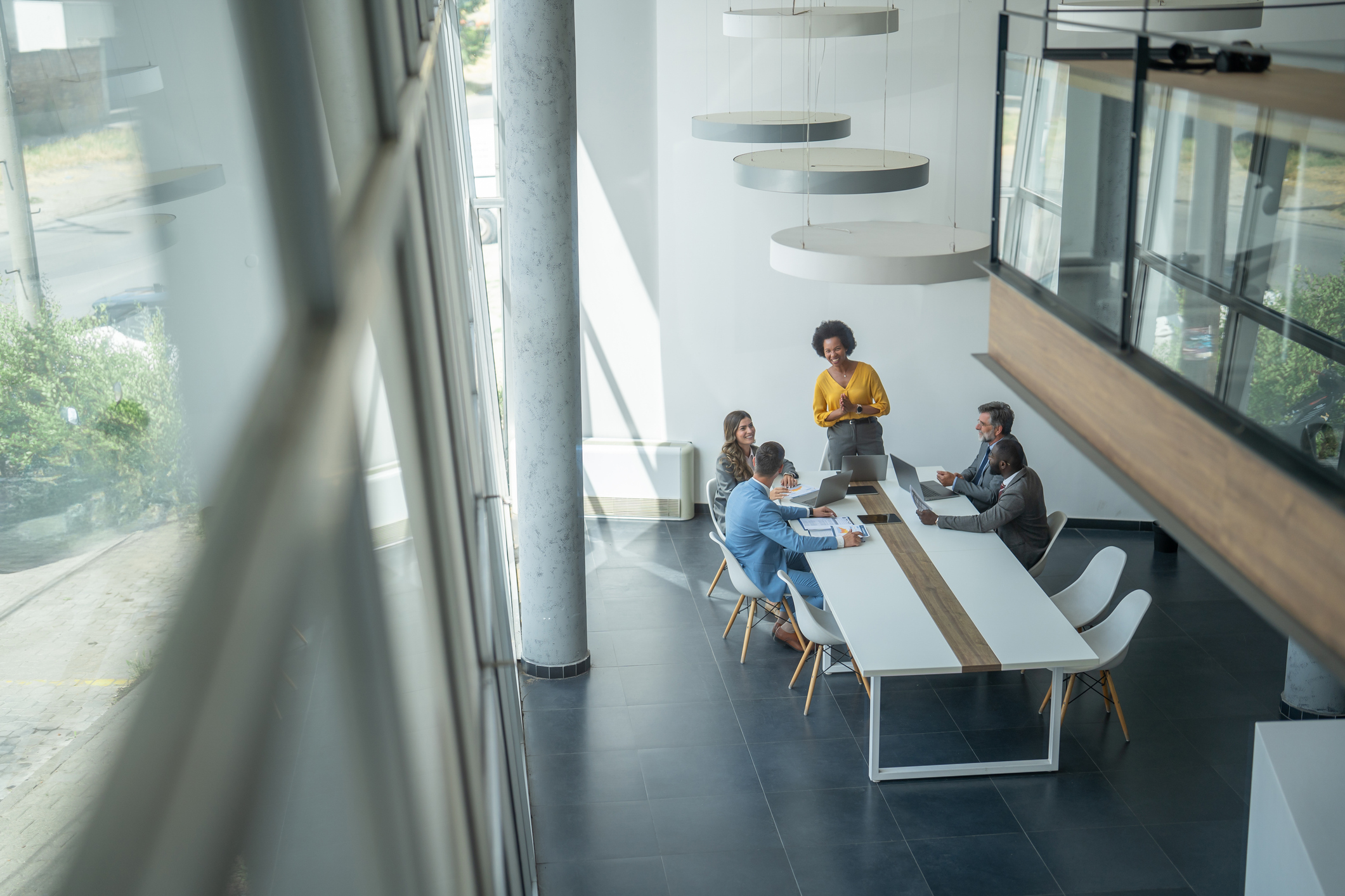 A group of people sat around a table in an office