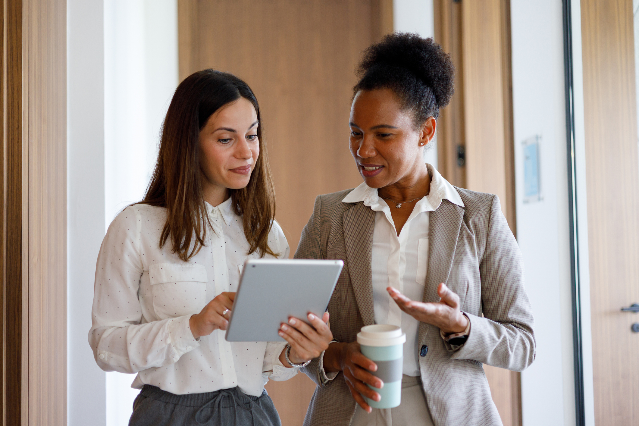 Two women reviewing information on a tablet