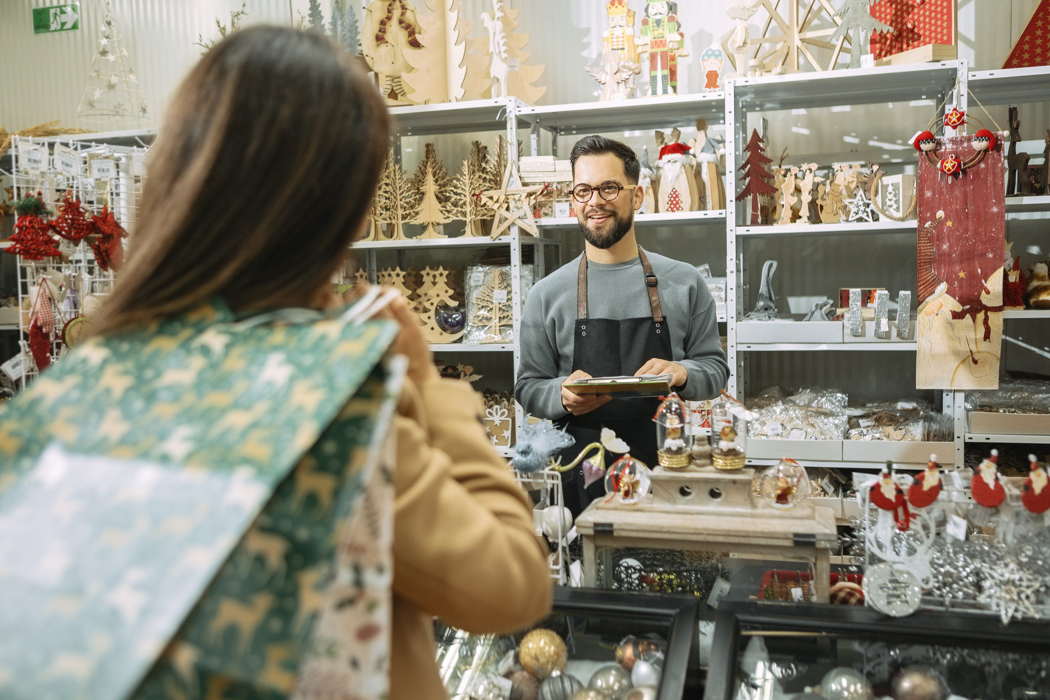 A women checking out items at a holiday sale