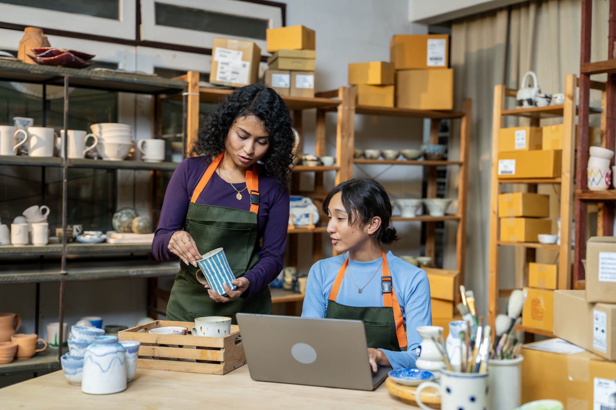 Two women packing an item