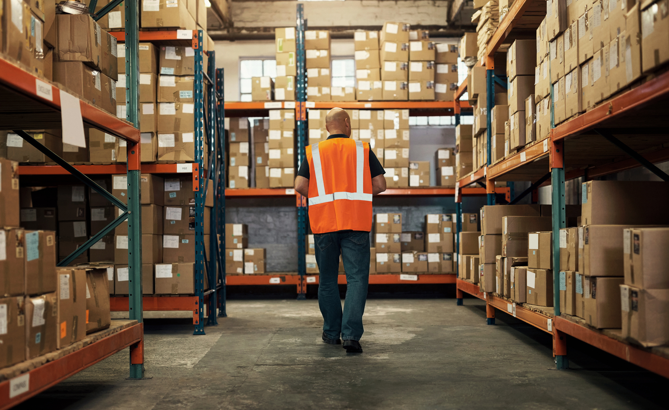 A man walking through a warehouse