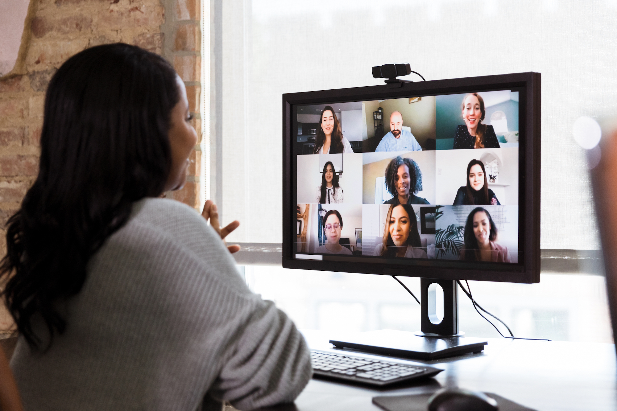 Woman on video conference with nine other participants
