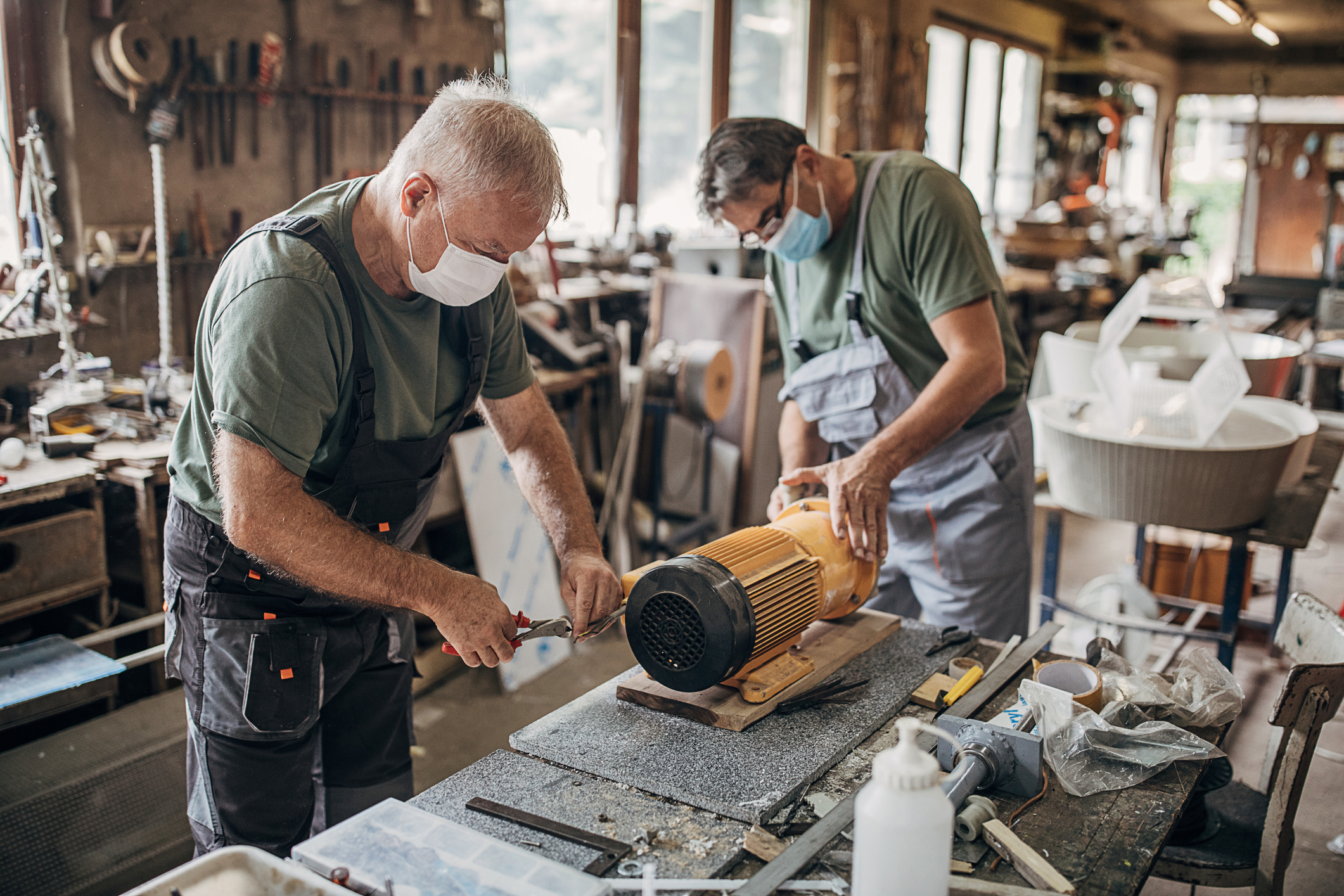 Two men working in a woodworking studio. 