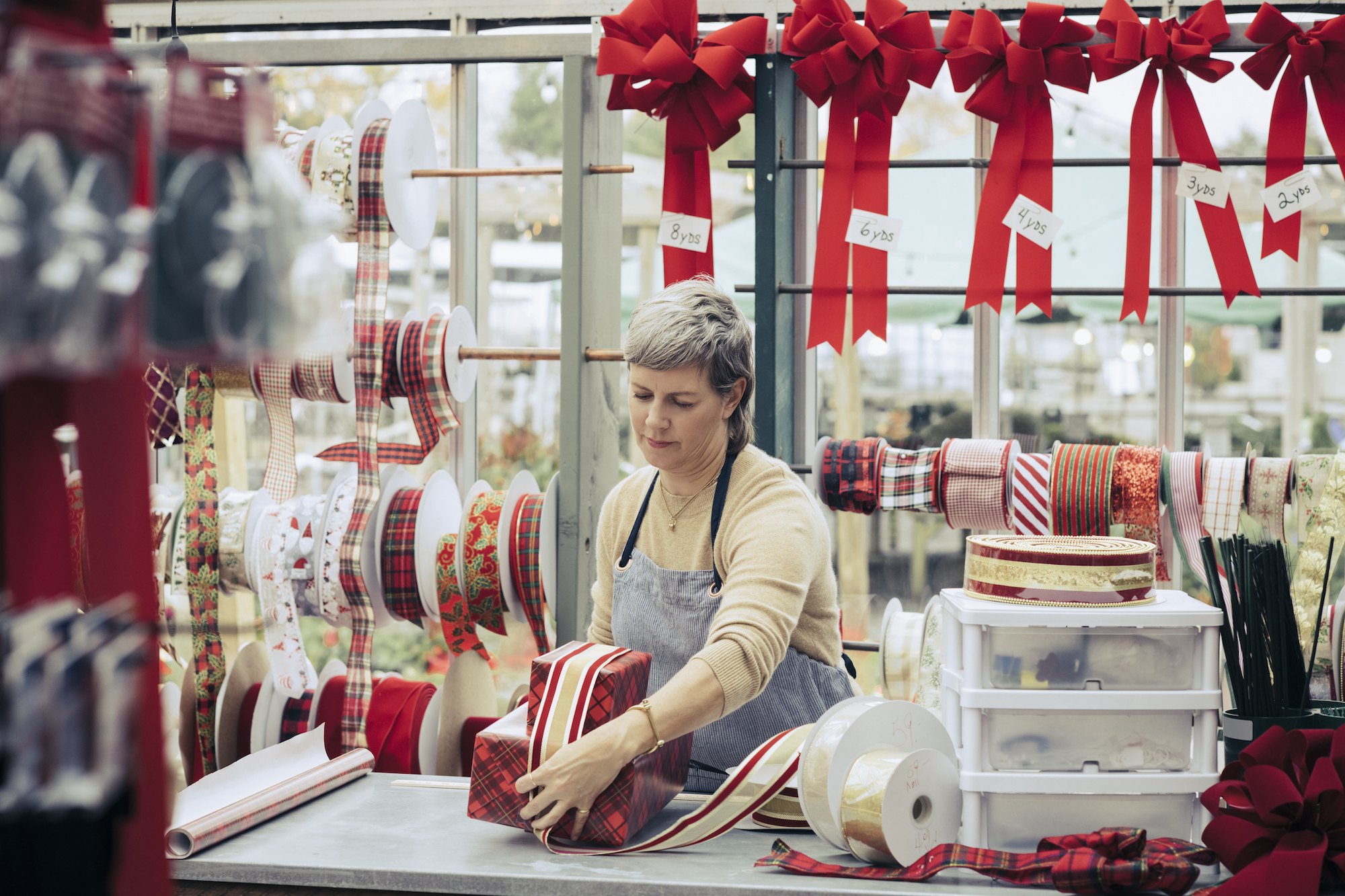 A woman wrapping presents in a shop