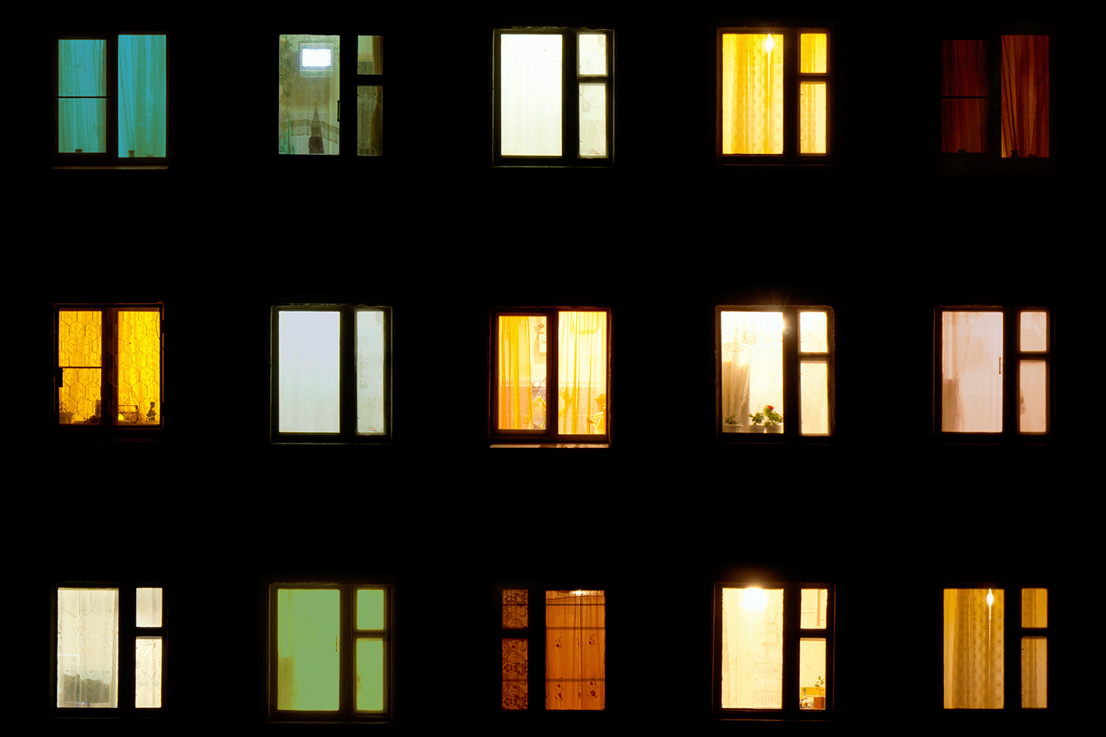 Apartment windows' lights going on and off.